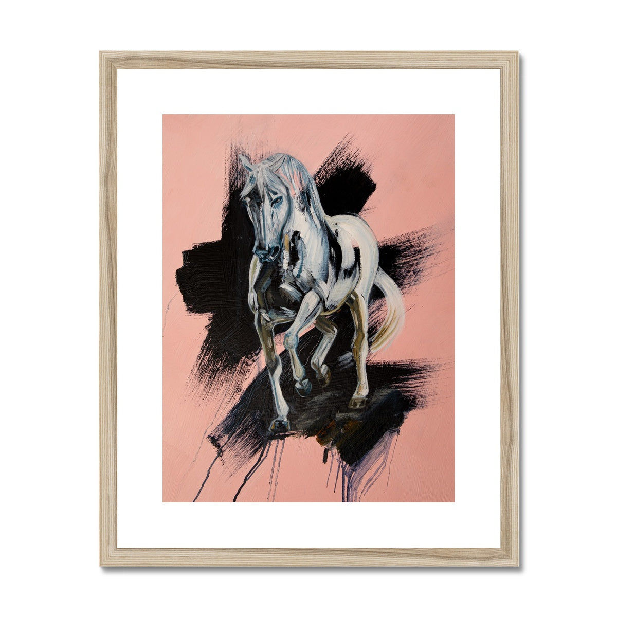 White horse trotting towards you, pink background with black splash portrait. Framed and mounted print with wood look frame